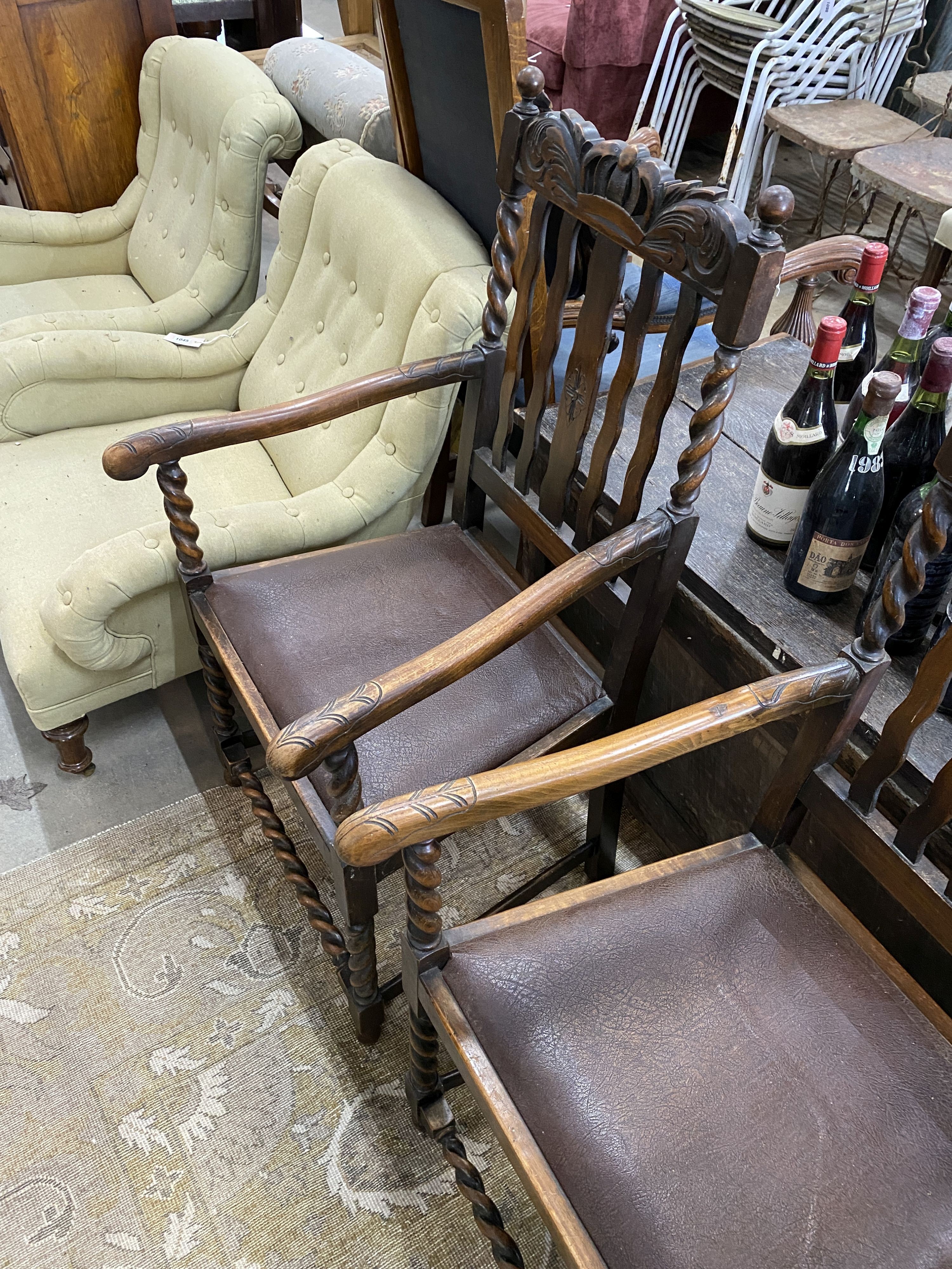 A pair of 1930’s carved beech Carolean style elbow chairs